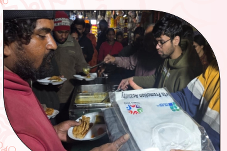 Volunteers serving meals to community members during the programme.