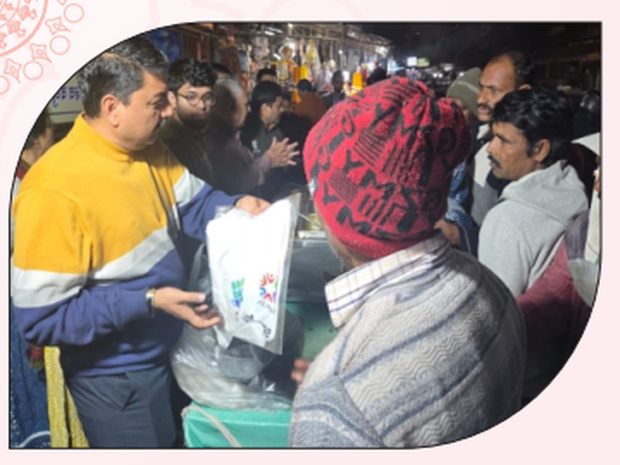 A volunteer distributing relief materials to community members.