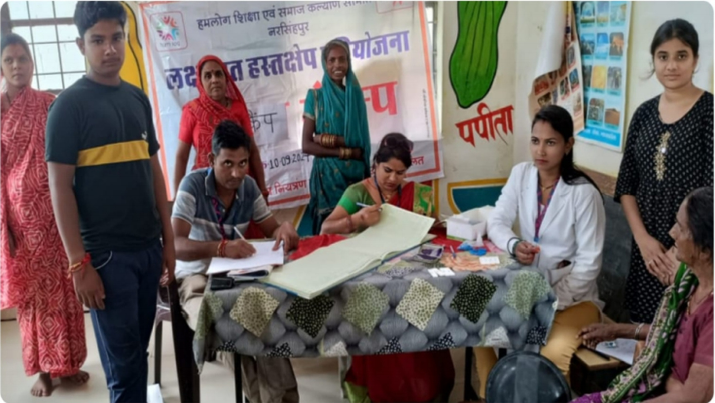 Health workers recording information and providing consultation at the camp.