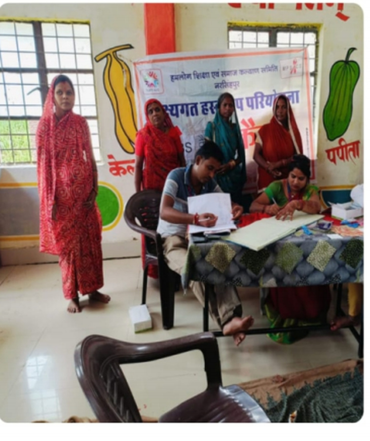 Community health camp staff assisting participants at the consultation table.